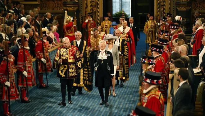 Gentleman Usher of the Black Rod, David Leakey leads the Queen's procession through the Royal Gallery to the House of Lords