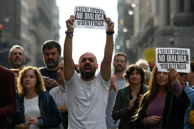 People protest holding placards reading "Spanish State does not dialogue, it sentences" in Barcelona on October 14, 2019, after Spain&squot;s Supreme Court sentenced nine Catalan leaders to prison terms