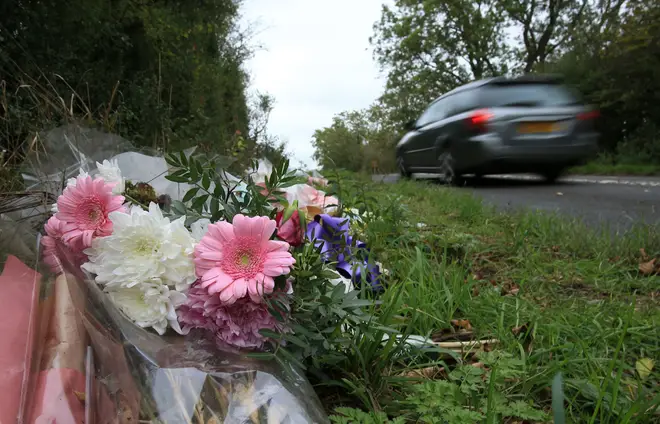 Floral tributes lay on the roadside near RAF Croughton in Northamptonshire on October 10, 2019, at the spot where Harry Dunn was killed as he travelled along the B4031 on August 27