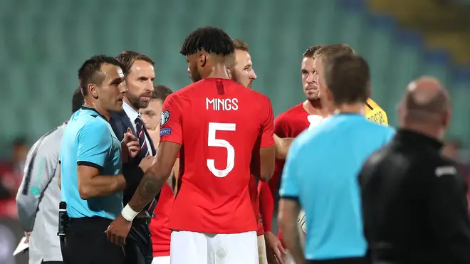 Referee Ivan Bebek talking with England defender Tyrone Mings and manager Gareth Southgate