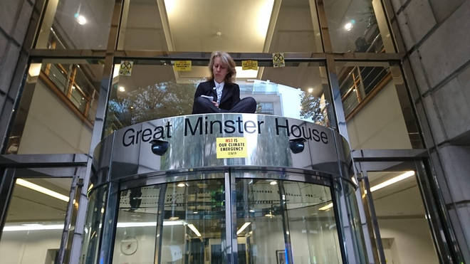 One protester climbed the doors of the Department of Transport