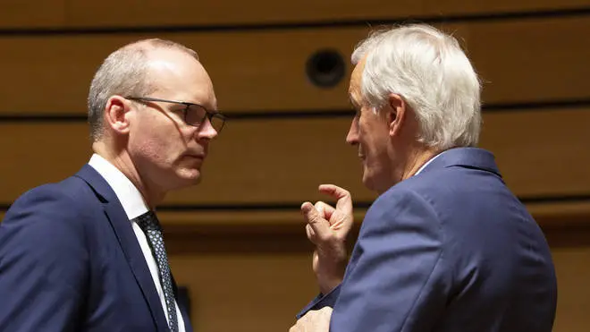 European Union chief Brexit negotiator Michel Barnier, right, speaks with Irish Foreign Minister Simon Coveney, left.