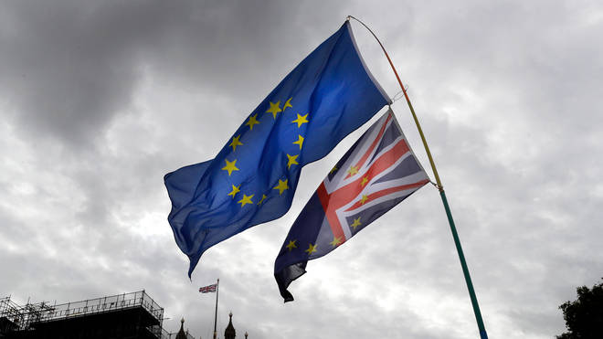 A European Union flag flies next to a Union Flag near Parliament