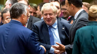 Boris Johnson shakes hands with EU leaders after agreeing a Brexit deal