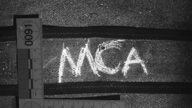 The MCA marking found on the strap of his rucksack