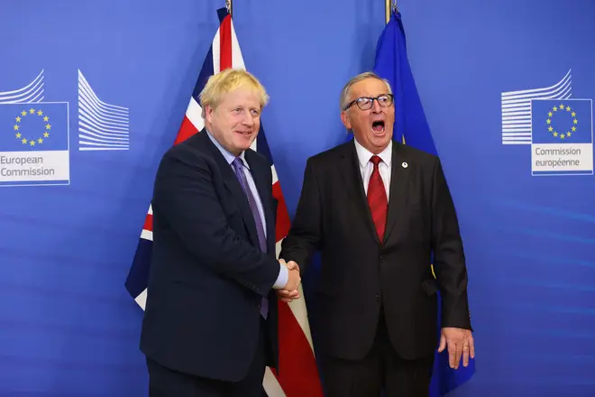 Boris Johnson and European Commission President Jean-Claude Juncker shake hands as they meet the press during an EU summit in Brussels