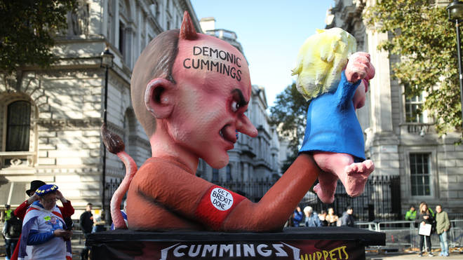 Protesters push a float depicting Dominic Cummings using Prime Minister Boris Johnson as a puppet down Whitehall ahead of an anit-Brexit march in London.