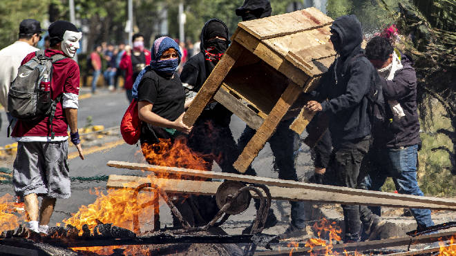 Demonstrators build a burning barricade during a protest in Santiago, Chile