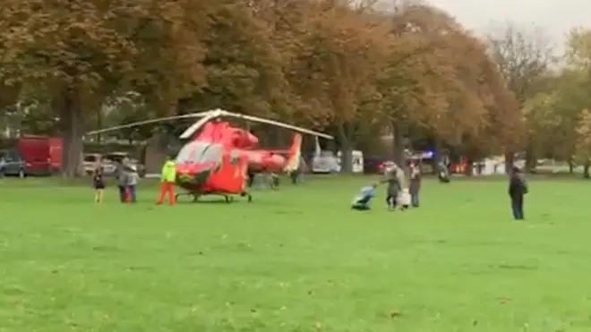 The air ambulance is seen at the scene of a triple stabbing in Peckham Rye