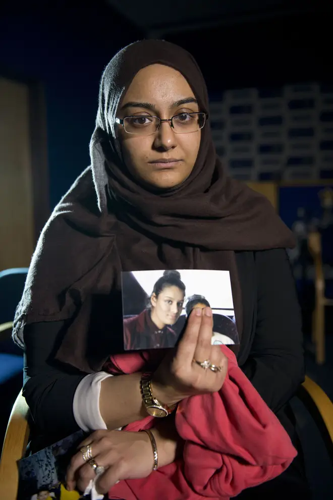 Shamima Begum's sister Renu holds a photo of her sibling