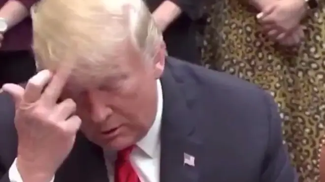 Donald Trump was filmed making an apparent rude gesture towards the woman
