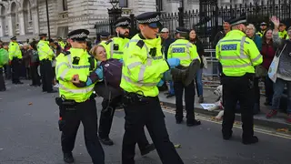 Police carry away an Extinction Rebellion protester