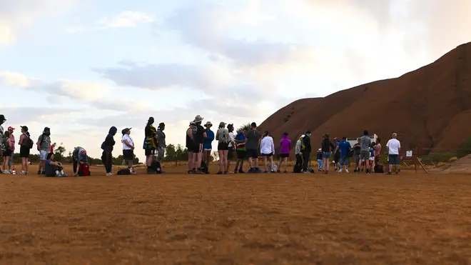 Tourists come from all over the world to climb Uluru