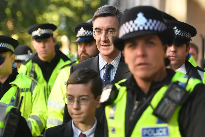 Jacob Rees-Mogg and his son Peter being escorted by police after leaving Parliament on Saturday