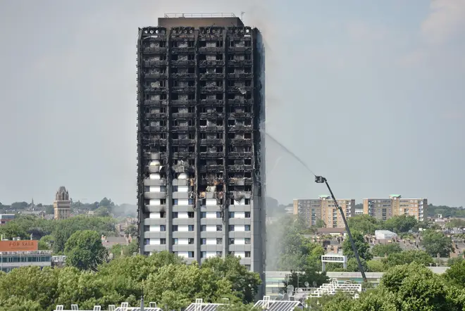 Firefighters spraying water after the fire engulfed Grenfell Tower in west London