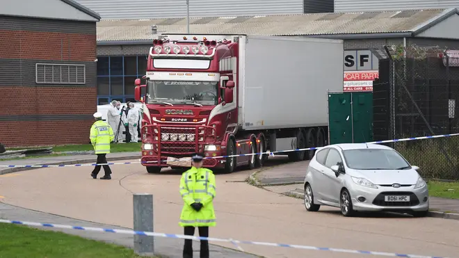 Forensic officers investigate the lorry in Grays, Essex