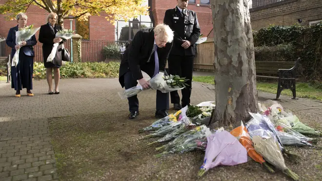 Mr Johnson laid flowers in a memorial garden for the 39 victims