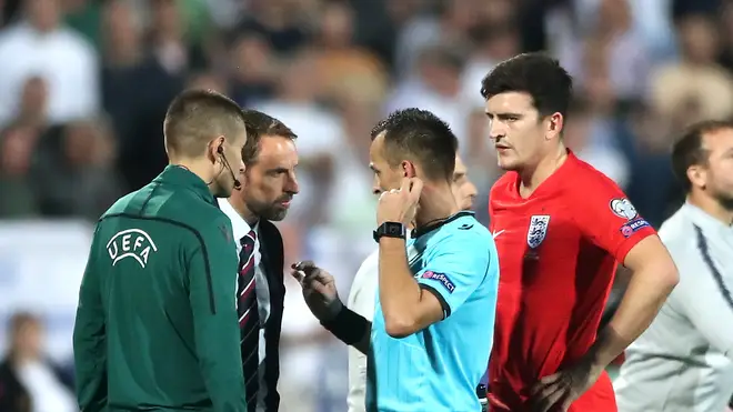 Match referee Ivan Bebek speaks to England manager Gareth Southgate