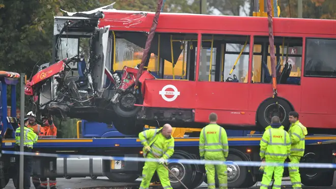 The bus is removed from the scene of the crash in Orpington