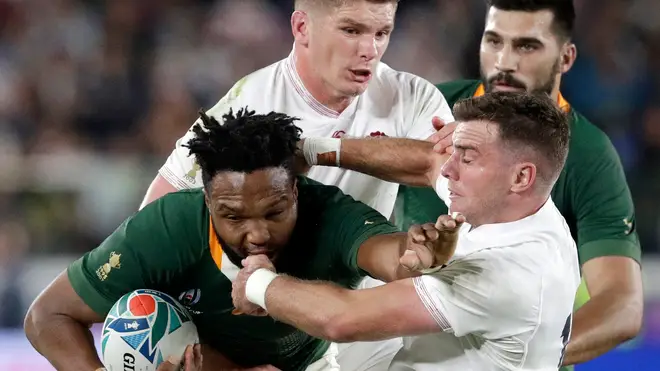 South Africa's Lukhanyo Am is tackled by England's Owen Farrell and George Ford during the Rugby World Cup final