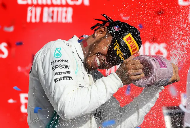 Lewis Hamilton celebrates on the podium during the US F1 Grand Prix