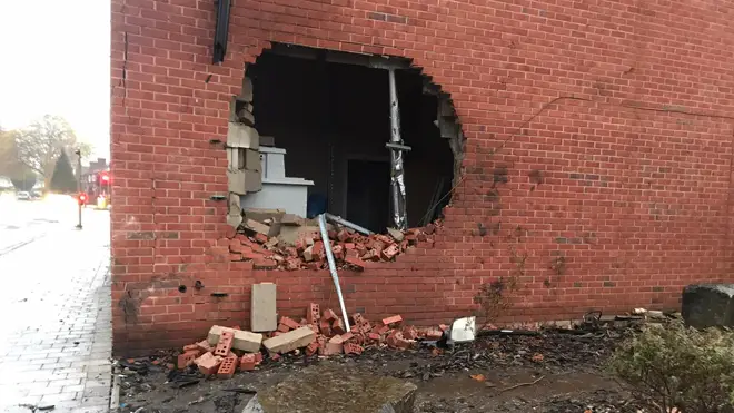 The car punched a hole in the wall of a building in Burnage, Manchester