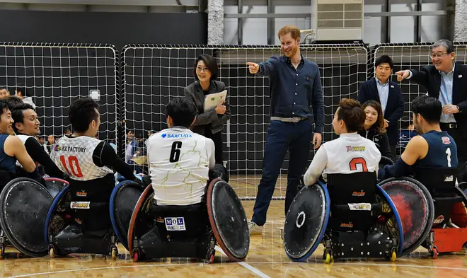 Prince Harry speaks with para athletes during the wheel-chair rugby training session at the Para Arena in Tokyo, Japan