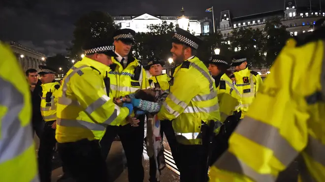 An activist being removed from Trafalgar Square by police