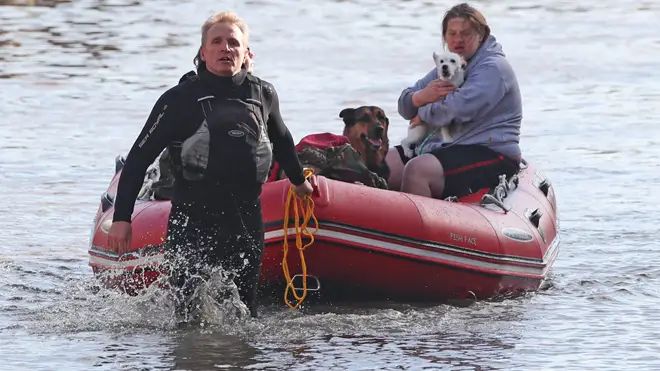 A flood victim is taken to safety with two dogs in Doncaster