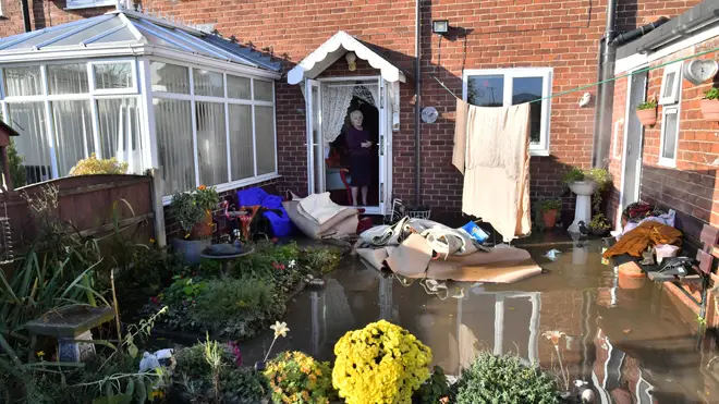 Dossie Croucher standing at her backdoor looking at her flooded garden in Fishlake, Doncaster