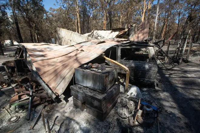 Damage caused by bushfire is seen at resident Brian Williams' resort at Lake Cooroibah Road in Noosa Shire