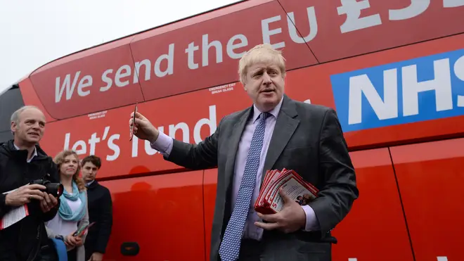 Boris Johnson stands in front of the 'Brexit bus'.
