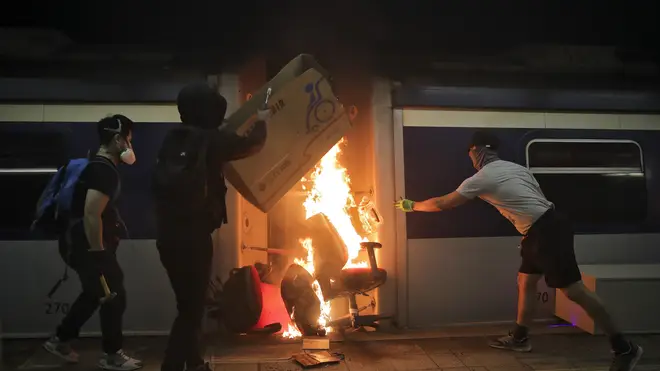 Students burn a train inside the Chinese University MTR station
