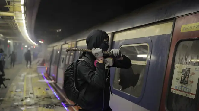 A student vandalizes a train parked inside the Chinese University MTR station in Hong Kong