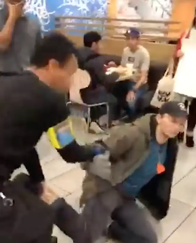 At one point a protester is dragged by his foot
