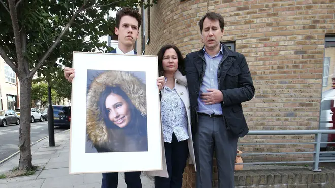 Nadim and Tanya Ednan-Laperouse, with their son Alex, holding a picture of Natasha