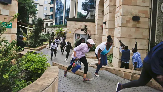 People flee the DusitD2 hotel complex during the January 15 attack