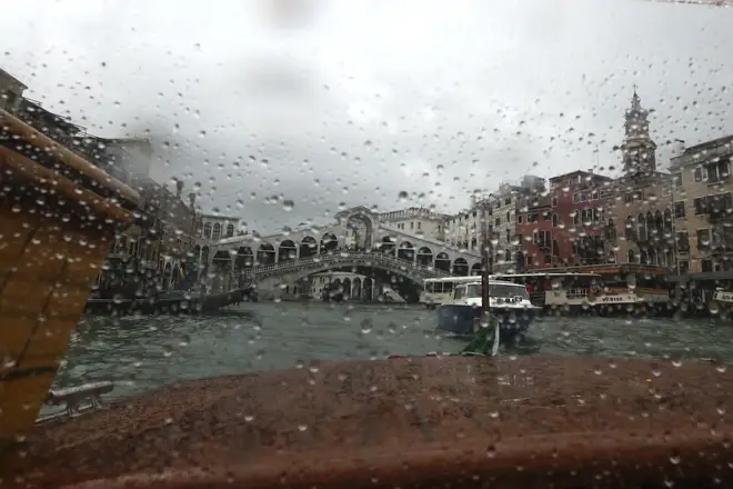 The Rialto bridge is seen from a taxi boat in Venice