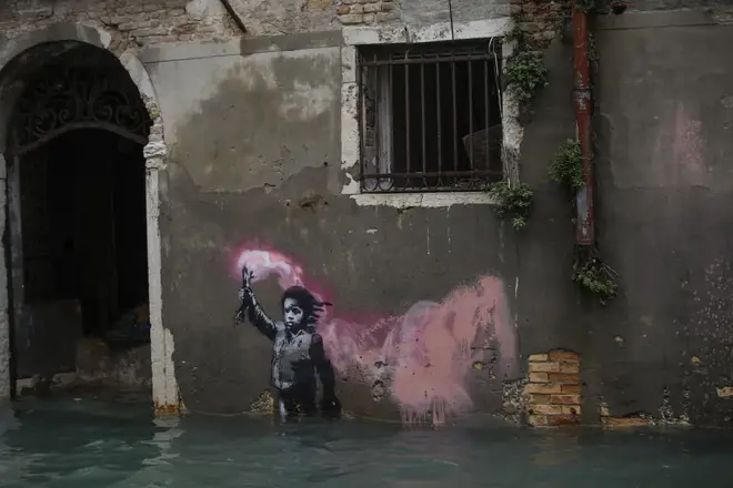 Banksy's migrant child mural is partially submerged in Venice