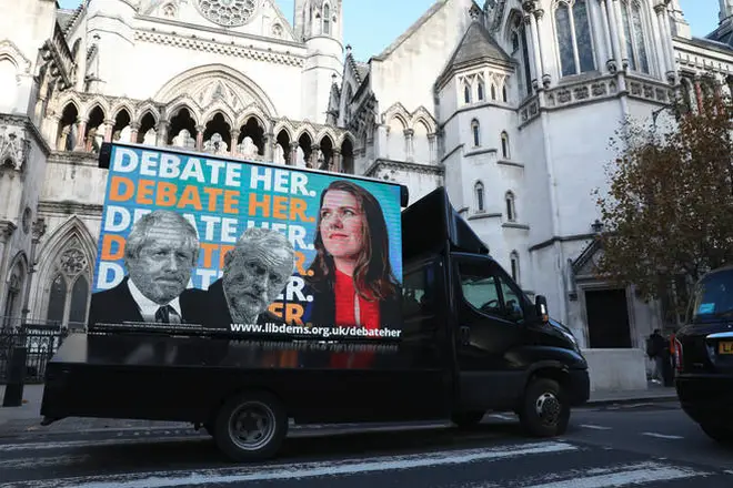 An advertising van showing Boris Johnson, Jeremy Corbyn and Jo Swinson.