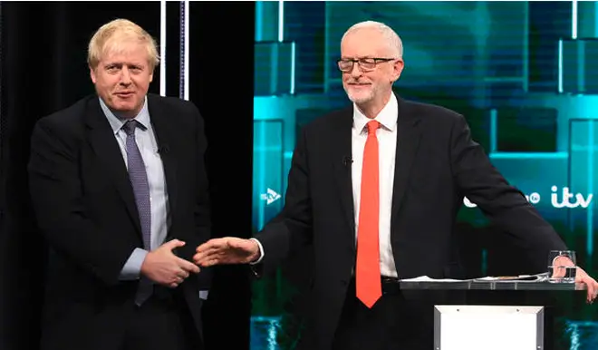 Mr Johnson and Mr Corbyn shake hands during the debate.