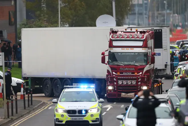 The container lorry, in which 39 people were found dead inside being driven away under escort from Waterglade Industrial Park in Grays, Essex.