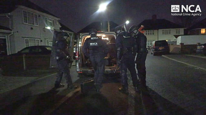 Specialist officers gear up before raiding the properties