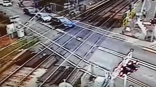 Learner driver crashes through barrier on level crossing.