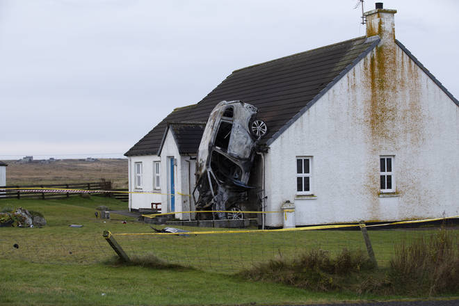 The car ended up standing on its bonnet against the house