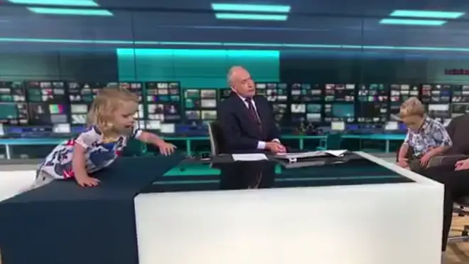 Toddler climbs on the desk live on ITV News